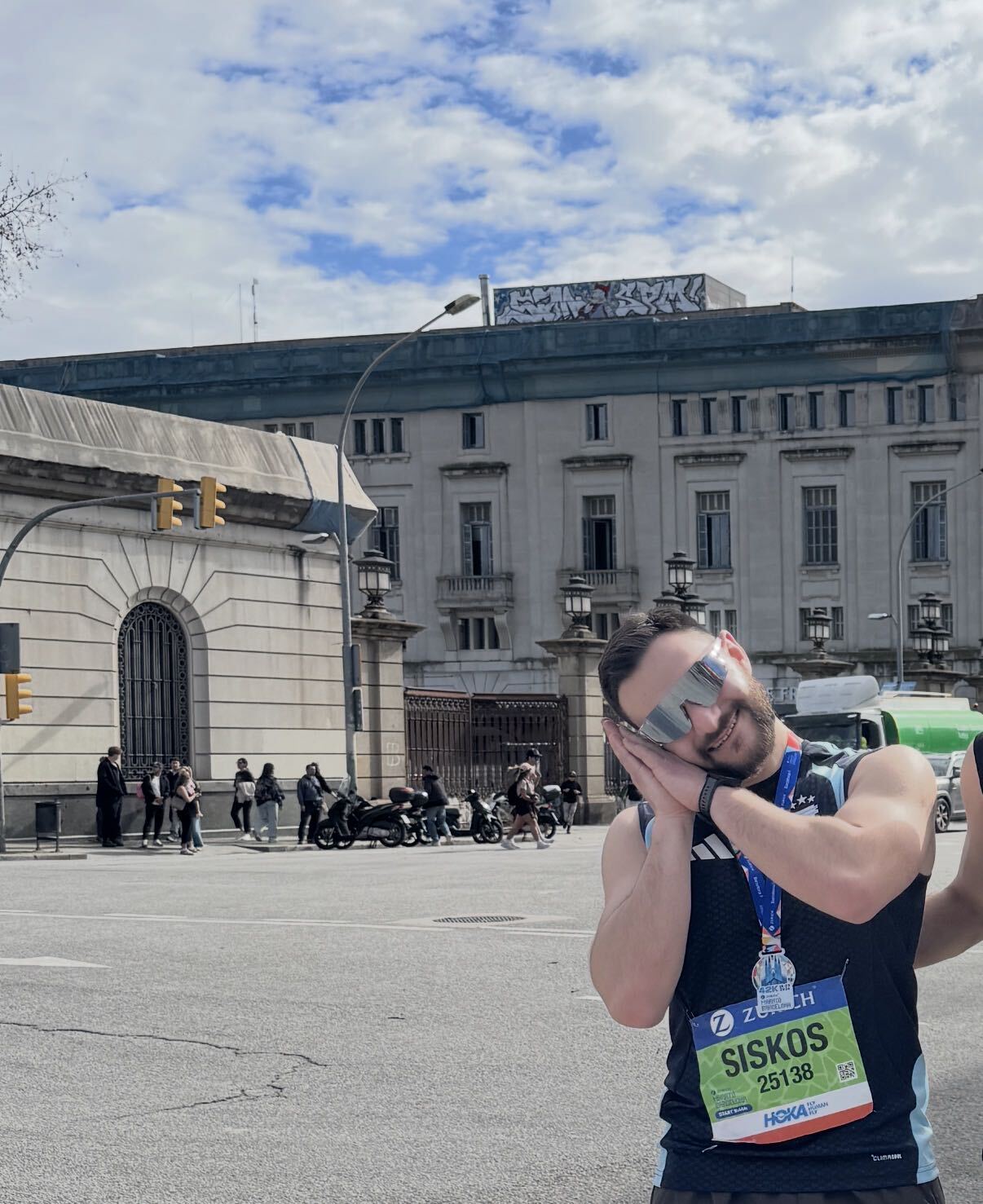 Siskos wearing a race bib and finisher’s medal after a marathon